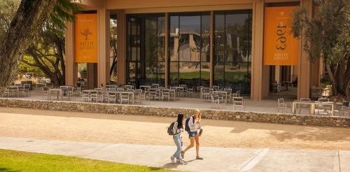 two students walk in front of the McConnell apron